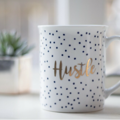 A mug with hustle written on the side