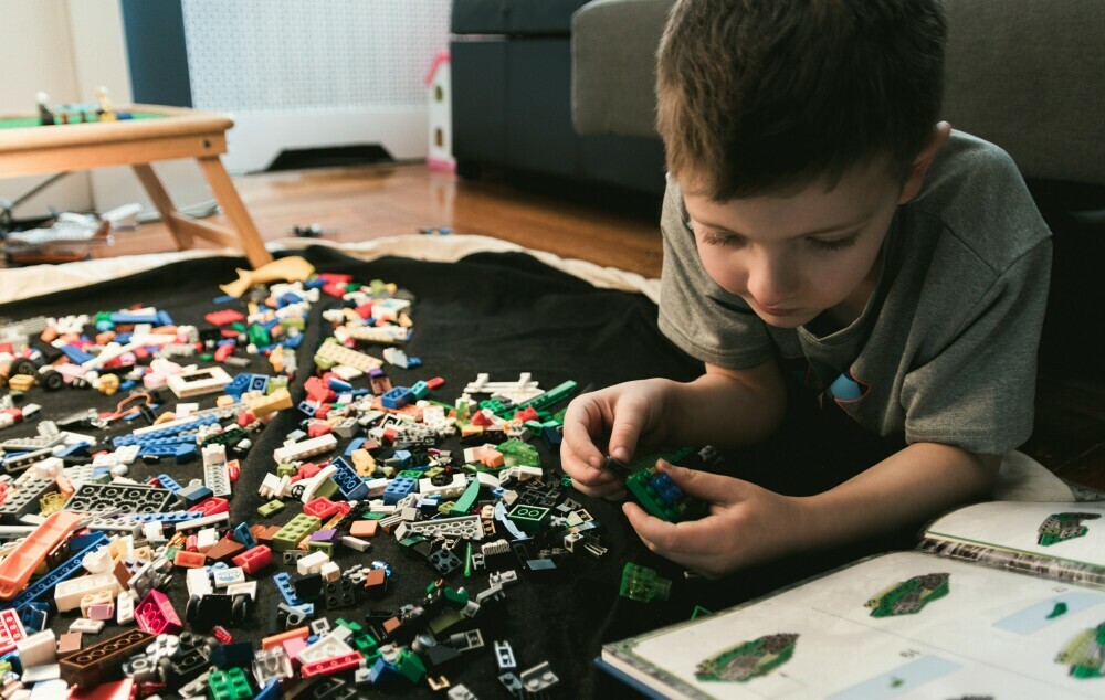 A young boy playing with lego